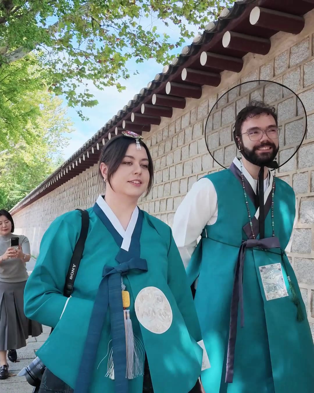 Couple in hanbok smiling near Gyeongbokgung